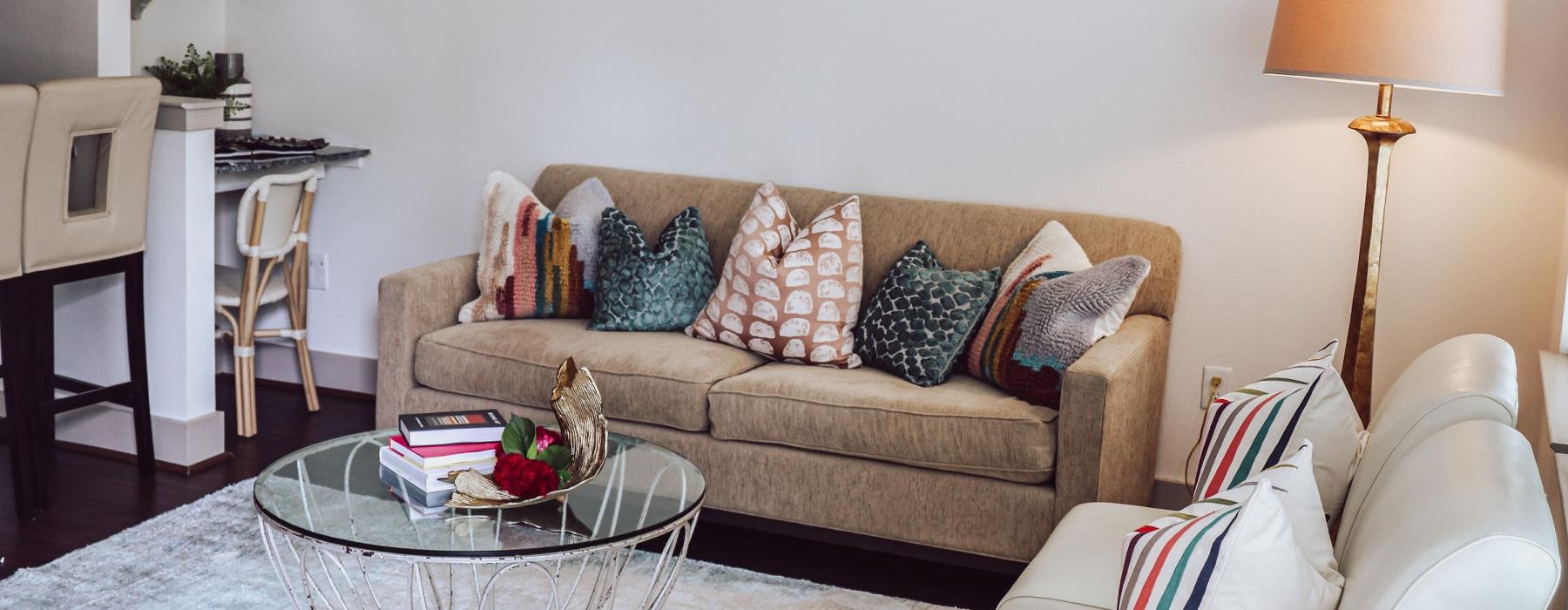 a living room with a fan and couches