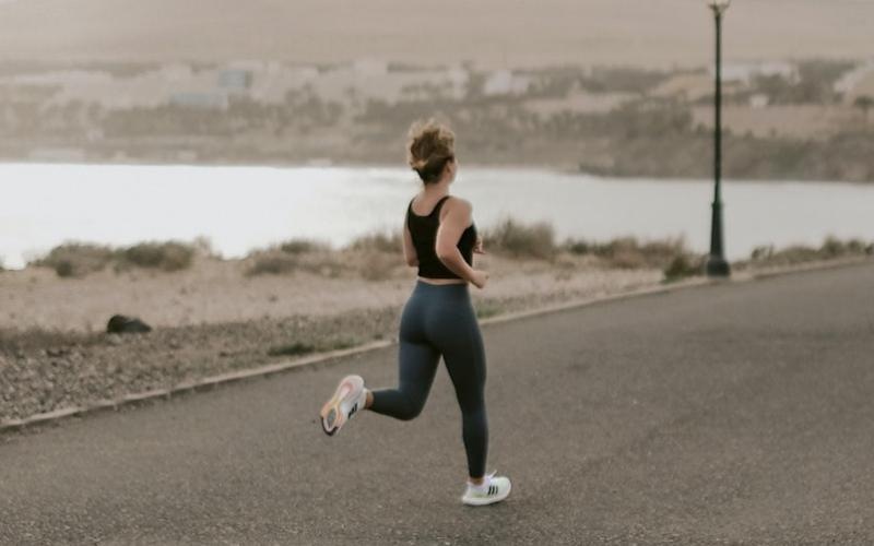 a woman running on a road